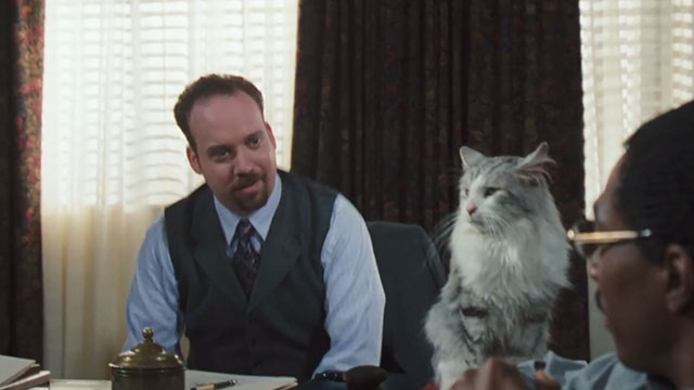 Doctor Dolittle - Blaine Paul Giamatti sitting at desk with longhaired gray and white tabby cat Bettleheim