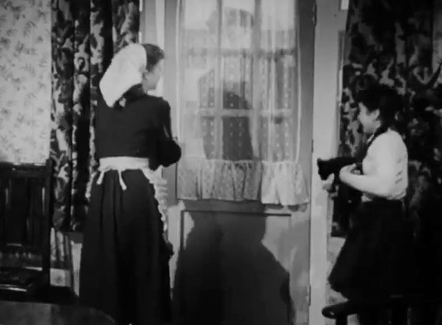 The Dog and the Diamonds - Linda Molly Osborne holding black kitten Frisky with mother at door