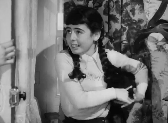 The Dog and the Diamonds - Linda Molly Osborne trying to hide black kitten Frisky behind her back