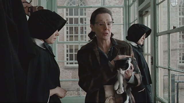 Doubt - Mrs. Carson Susan Blommaert carrying tuxedo cat past Sister Beauvier Meryl Streep and Sister James Amy Adams