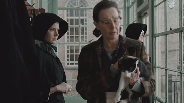 Doubt - Mrs. Carson Susan Blommaert carrying tuxedo cat past Sister Beauvier Meryl Streep and Sister James Amy Adams