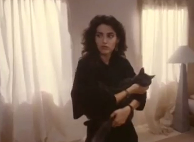 The Drifter - Julia Kim Delaney looking scared and holding gray cat Steve