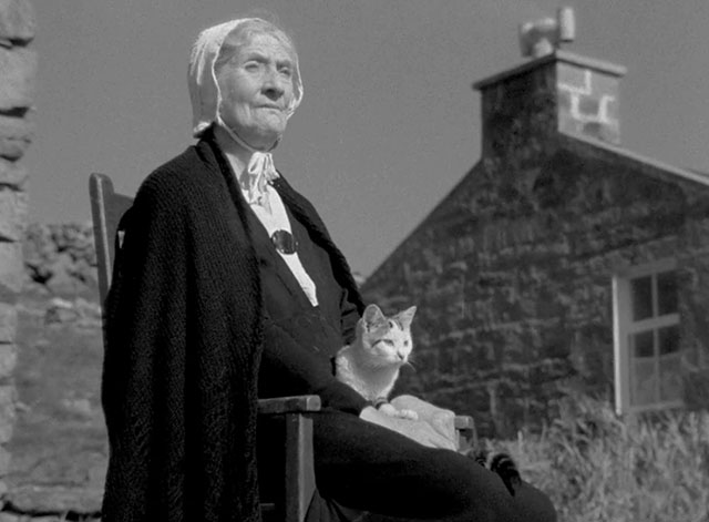 The Edge of the World - grandmother Jean Kitty Kirwan sitting in chair with tabby and white cat on lap