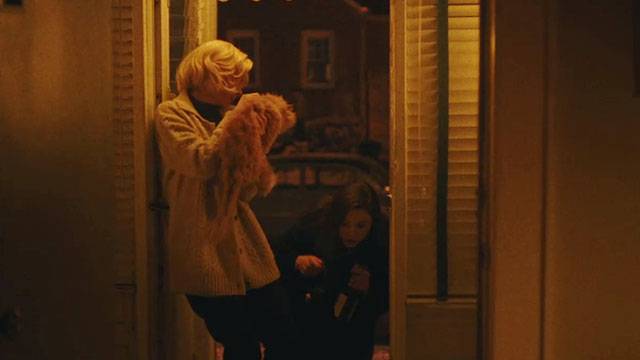 Eileen - Rebecca Anne Hathaway holding cream colored Selkirk Rex Persian cat at doorway with Thomasin McKenzie