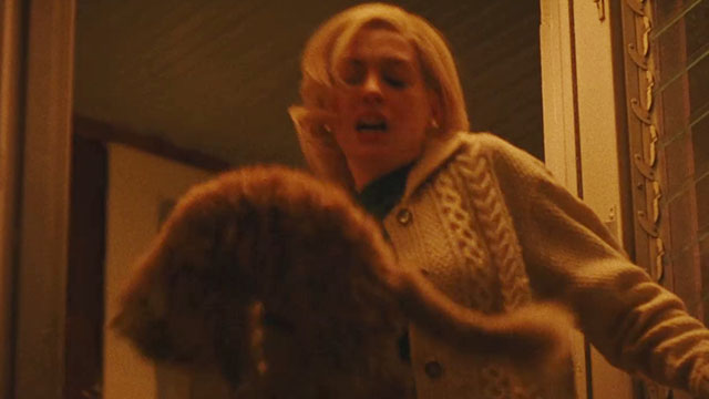 Eileen - Rebecca Anne Hathaway holding cream colored Selkirk Rex Persian cat at doorway