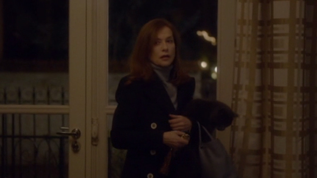 Elle - Mich&egrave;le Isabelle Huppert holding gray cat Marty