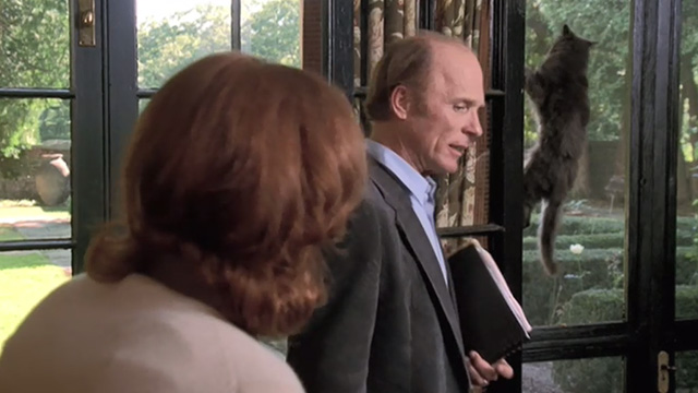 Empire Falls - long haired gray cat Timmy hanging on screen door behind Cindy Kate Burton and Miles Ed Harris