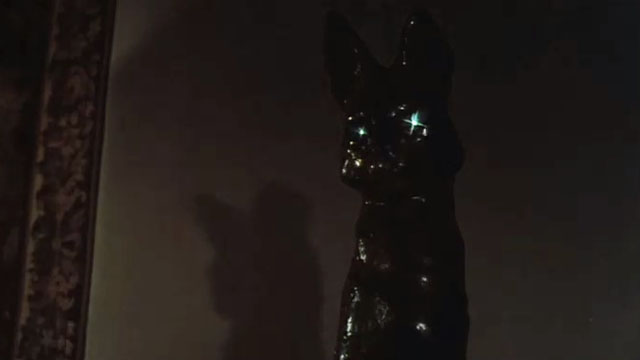 Endless Night - head of tall cat statue with eyes glowing in dark
