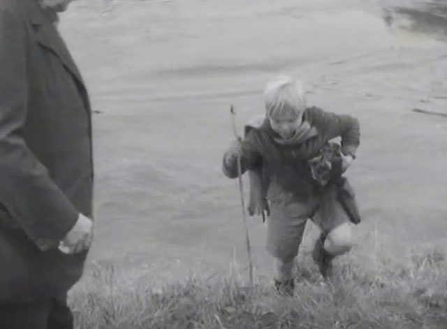 The End of the Road - Barney David Hannaford carrying soaked tabby kitten up bank from river