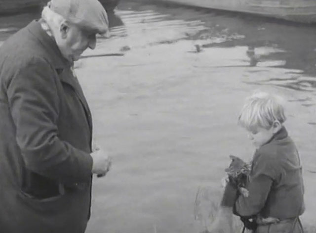 The End of the Road - Barney David Hannaford holding soaked tabby kitten with Mick Finlay Currie