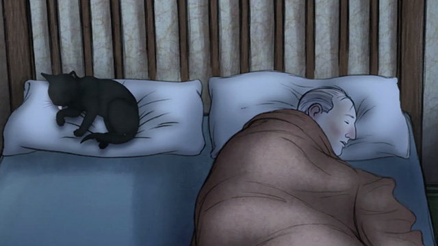 Ethel & Ernest - black cat Susie lying on pillow beside Ernest