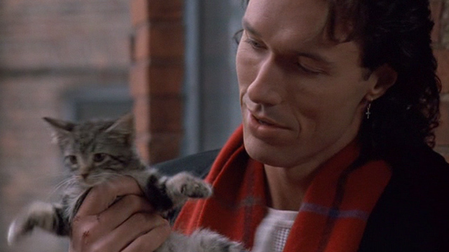 Excessive Force - Terry Thomas Ian Griffith holding up tabby kitten