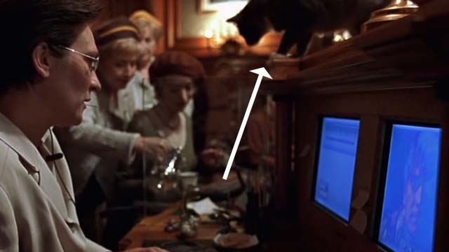 Eye of the Beholder - tuxedo cat on top of communication console behind Hilary k.d. lang