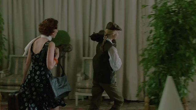 Face the Music - Julie Lysette Anthony carrying large gray cat Thelonious Gros Minet over shoulder with Lisa Molly Ringwald