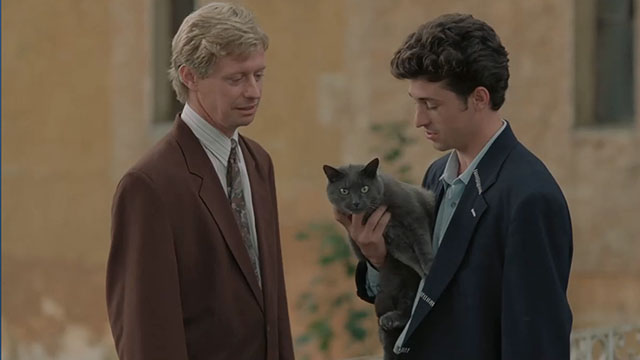 Face the Music - Charlie Patrick Dempsey holding large gray cat Thelonious Gros Minet with lawyer Daniel Dominic Jephcott