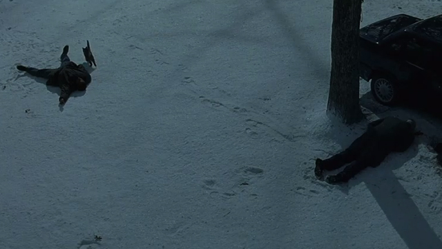 Fallen - brown tabby cat running in snow away from dead bodies