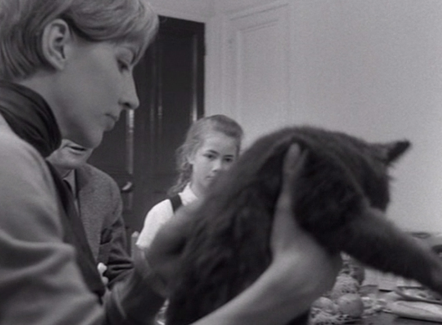 The Fire Within - mother sets gray cat on the floor