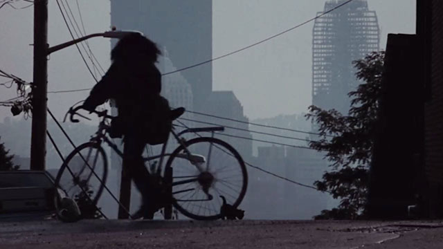 Flashdance - silhouette of Alex Jennifer Beals on bike with kitten on street