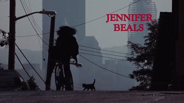 Flashdance - silhouette of Alex Jennifer Beals on bike with kitten on street