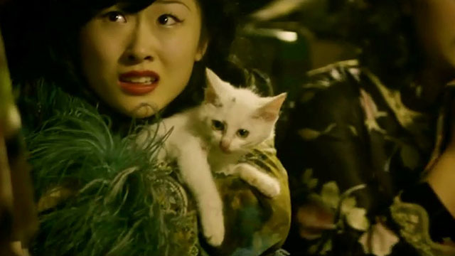 The Flowers of War - Mosquito Yuan Yangchunzi holding dirty white kitten