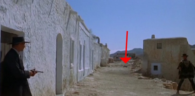 For a Few Dollars More - black cat in background behind Clint Eastwood and Lee Van Cleef