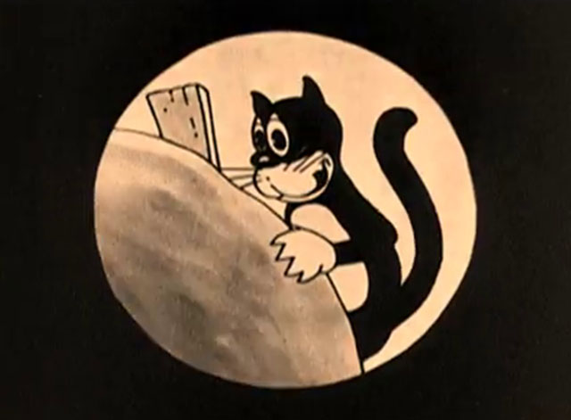 The Four Musicians of Bremen - black cartoon cat holding board behind rock and licking lips