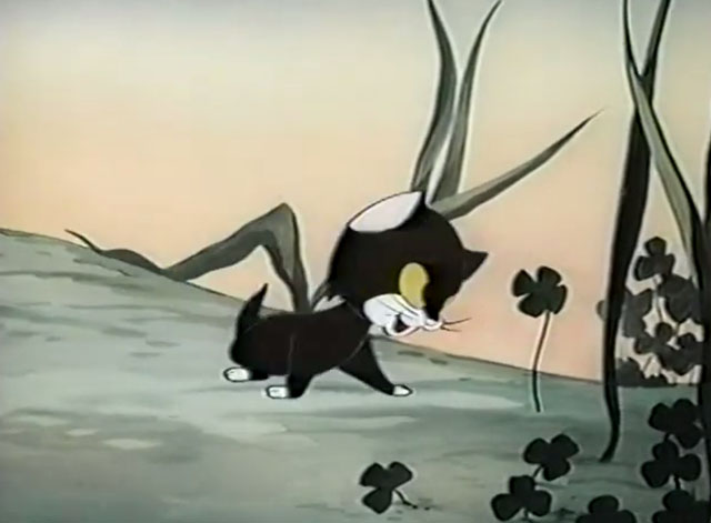 Frightday the 13th - cartoon black kitten Lucky looking at four leaf clover