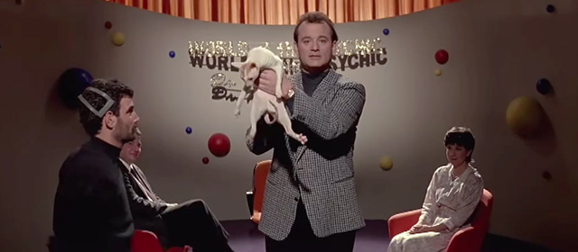 Ghostbusters II - Peter Venkman Bill Murray holding up hairless Cornish Rex cat on World of the Psychic