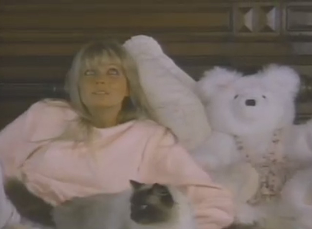 Ghosts Can't Do It - Katie Bo Derek lying on bed with Himalayan cat