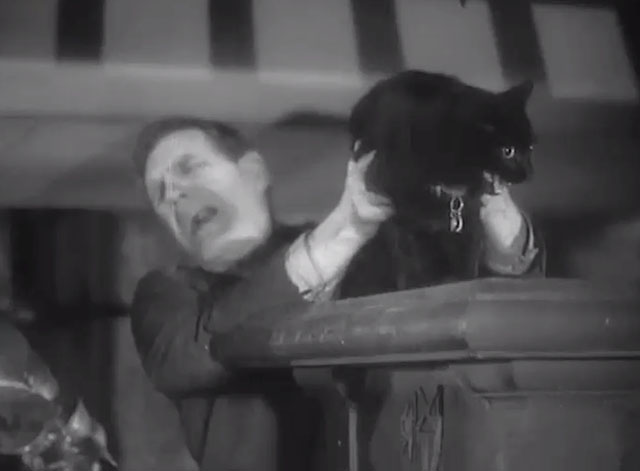 The Ghost of St. Michael's - nervous black cat Cleopatra being grabbed by Lamb Will Hay