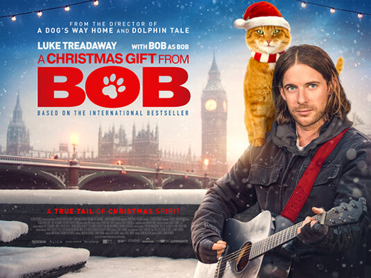 A Christmas Gift from Bob - James Bowen Luke Treadway with ginger tabby street cat Bob wearing Santa suit on shoulder in movie poster