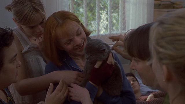 Girl, Interrupted - Polly Elizabeth Moss holding Ruby gray cat with other girls around