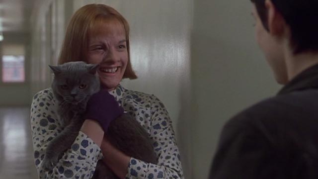 Girl, Interrupted - Polly Elizabeth Moss smiling and holding Ruby gray cat