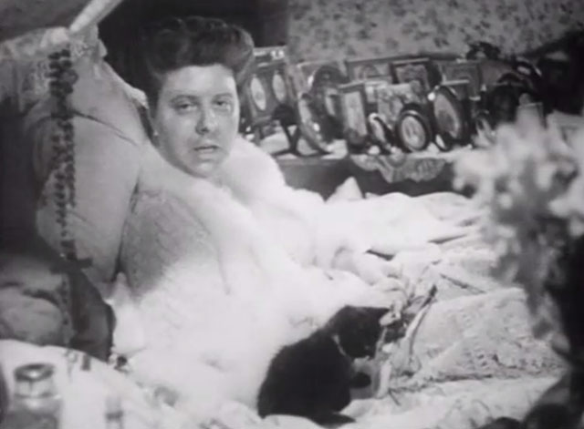 The Girl in the News - tuxedo kitten on bed with Miss Blakely Irene Handl