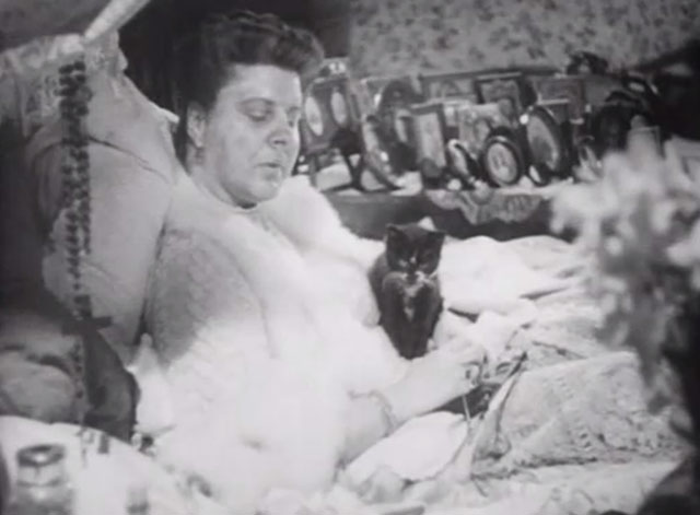The Girl in the News - tuxedo kitten on bed with Miss Blakely Irene Handl