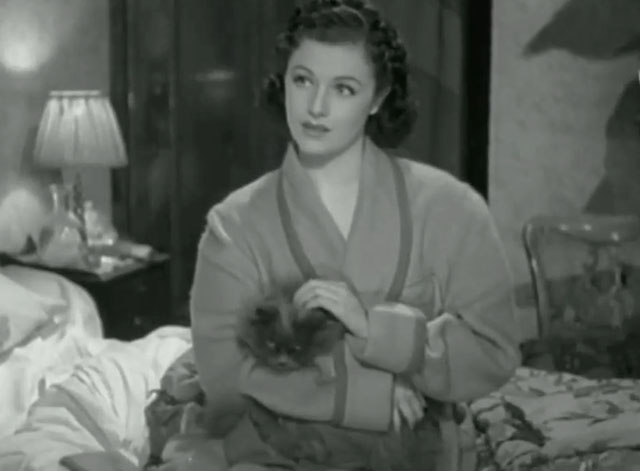 A Girl Must Live - Leslie Margaret Lockwood with gray Persian cat Jennie on bed