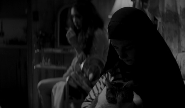 A Girl Walks Home Alone at Night - Masuka cat being held by The Girl