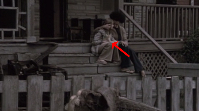 Glitter - young Billie Isabel Gomes with tabby kitten Whisper sitting outside burned house with Lillian Valarie Pettiford