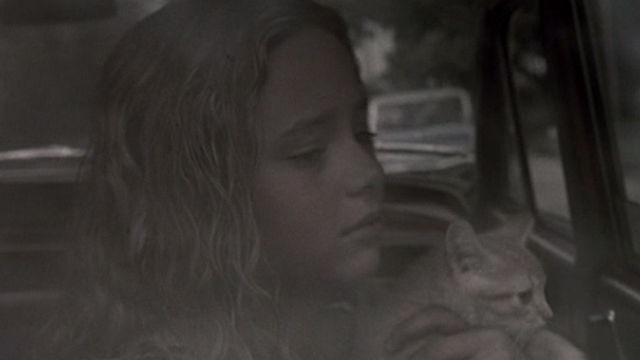 Glitter - young Billie Isabel Gomes with tabby kitten Whisper looking out back window of car