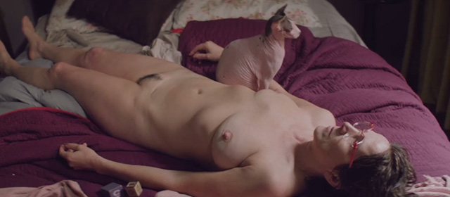 Gloria - Gloria Paulina Garcia lying naked on bed with hairless Sphynx cat