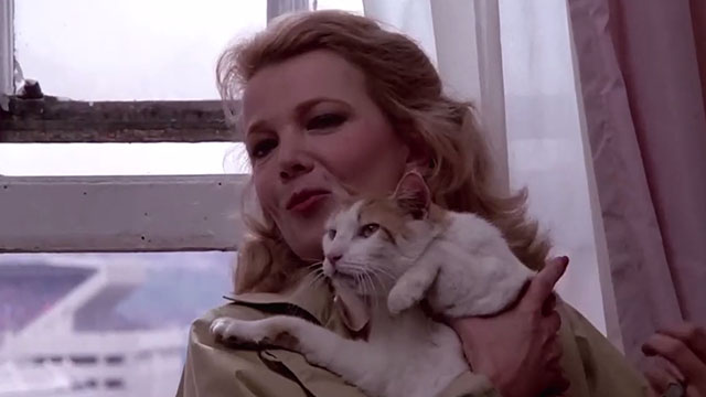 Gloria - Gena Rowlands holding orange and white tabby cat
