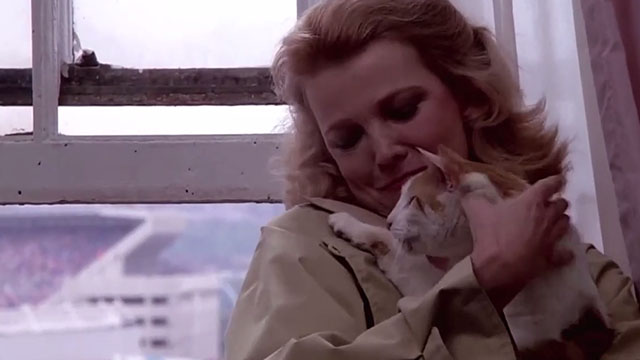Gloria - Gena Rowlands holding orange and white tabby cat