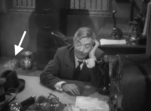 Go Chase Yourself - tabby cat in corner and warden Athur Stone at desk