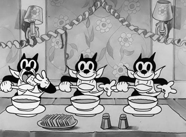 Goopy Geer - three cartoon black cats with soup bowls one eating cracker