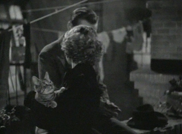 Grand Slam - tabby cat looking up while in Loretta Young's arms