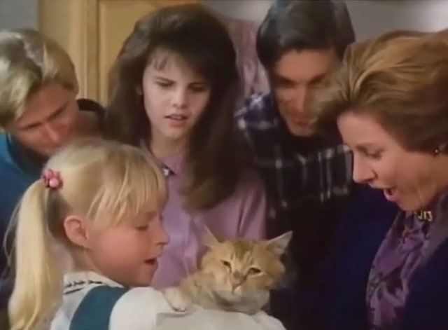 Grave Secrets The Legacy of Hilltop Drive - Carli Kimberly Cullum holding orange and white tabby cat Ginger with Jean Patty Duke and family