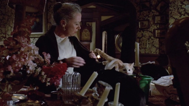 Gremlins - Mrs. Deagle Polly Holliday with orange and white cat Old Dollar Bill and other cats on table