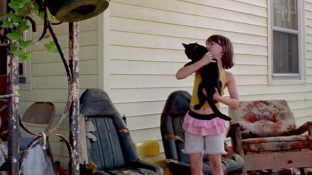 Gummo - black cat Foot Foot being picked up by Darby Dougherty.