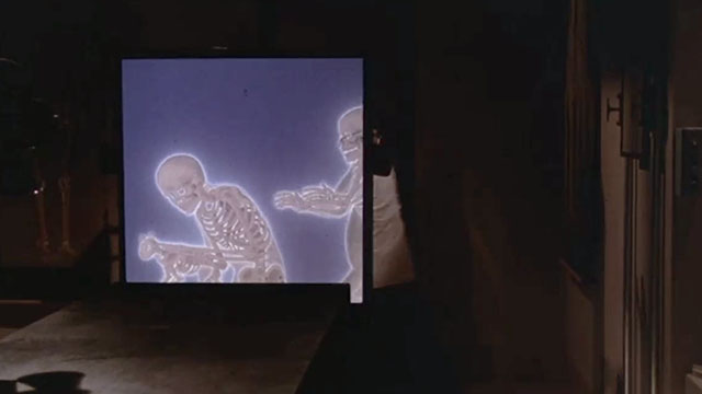 Gus - Skinner running behind X-ray machine showing skeletons of two humans and one cat