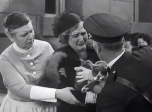Headline Shooter - Basket Murderess Mary MacLaren screaming as policeman takes gray and white cats away
